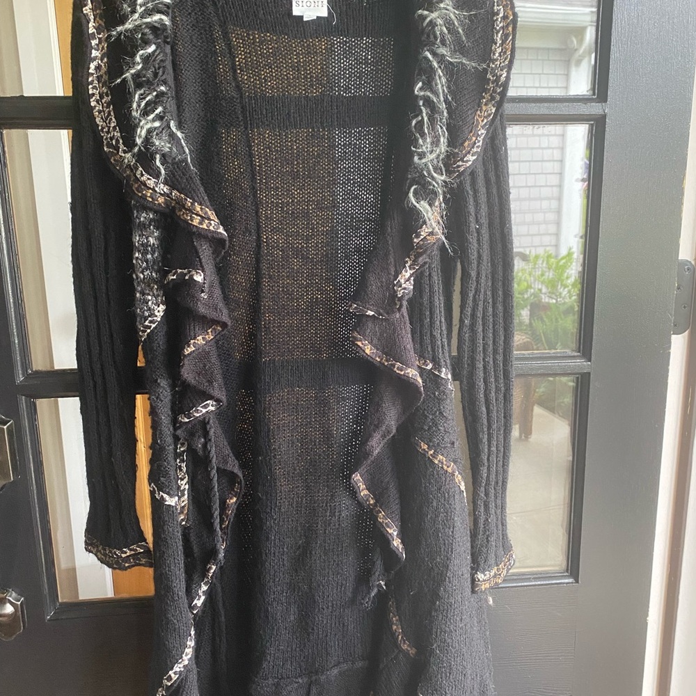 Sioni Studio small, but is a roomy, long small. I love this sweater with boots.